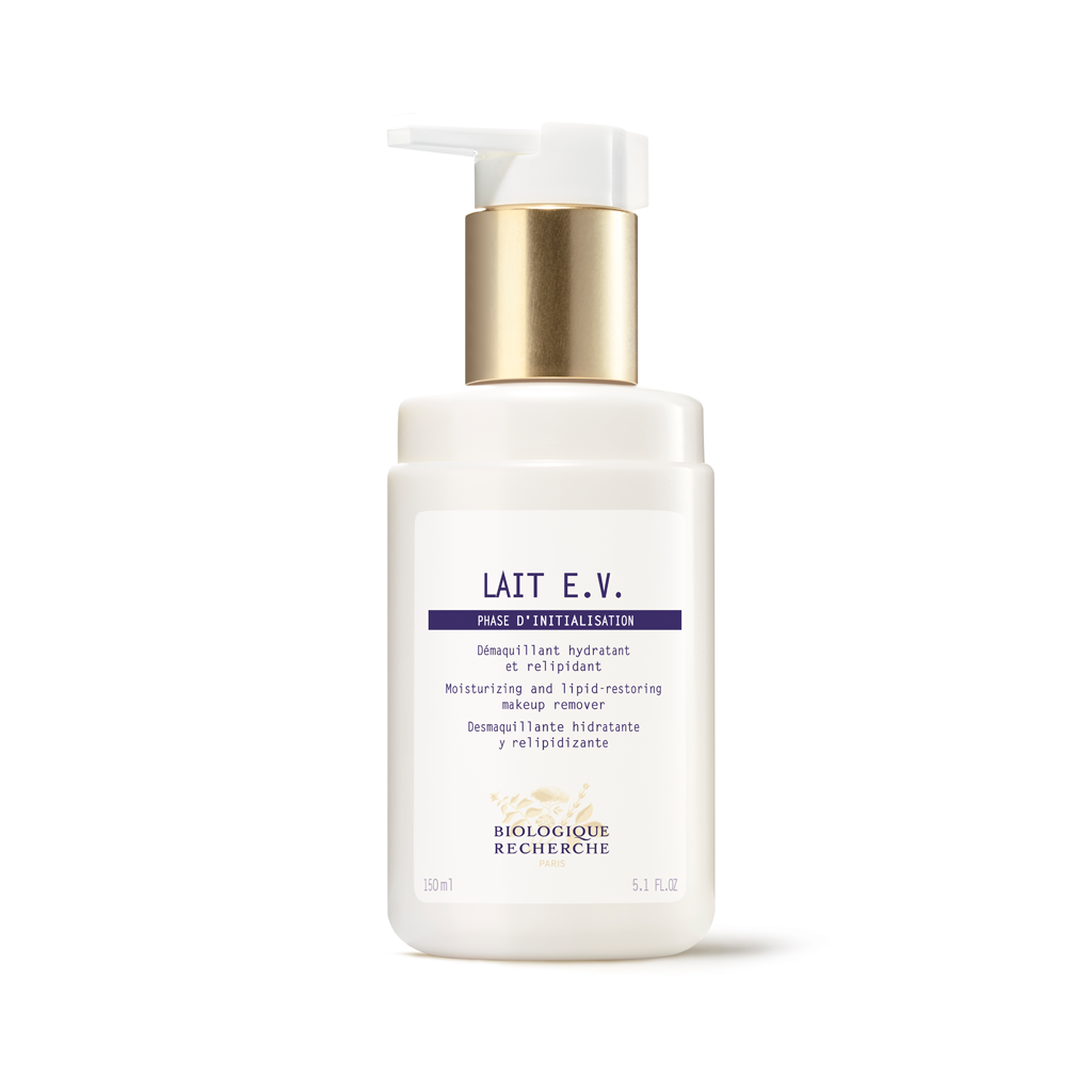White skincare bottle with gold pump on a white background