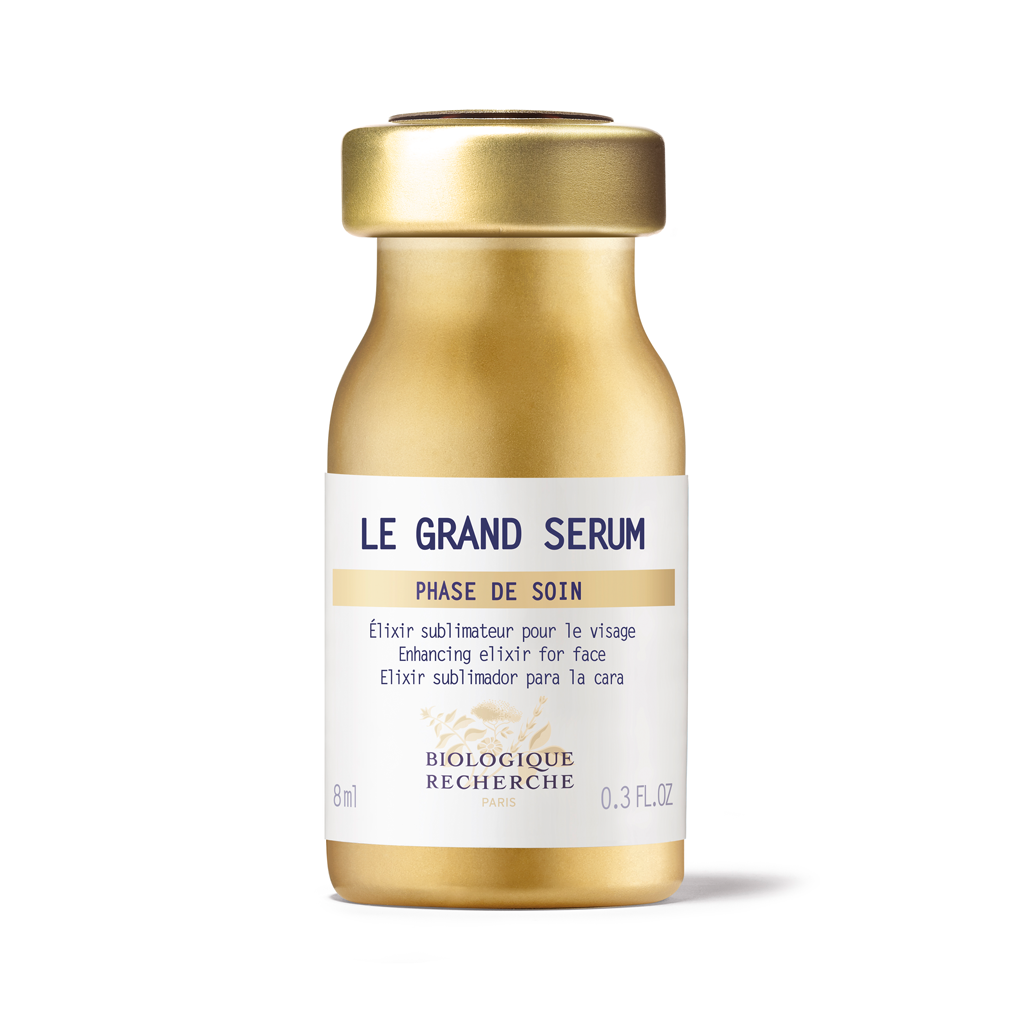 Gold serum bottle with white label on a white background